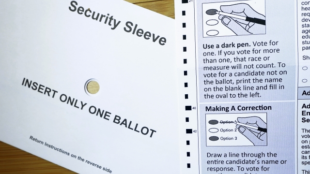 A portion of a Washington state mail-in ballot is shown with instructions for marking voter choices and a security sleeve