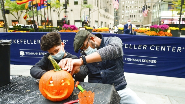 Sharif Butler and his nephew Chace, 11, carve pumpkins at Rockefeller Center