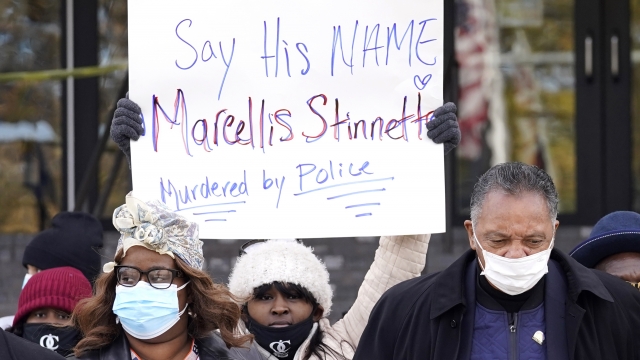 Marcellis Stinnette's mother holding a sign as she walks to a press conference.