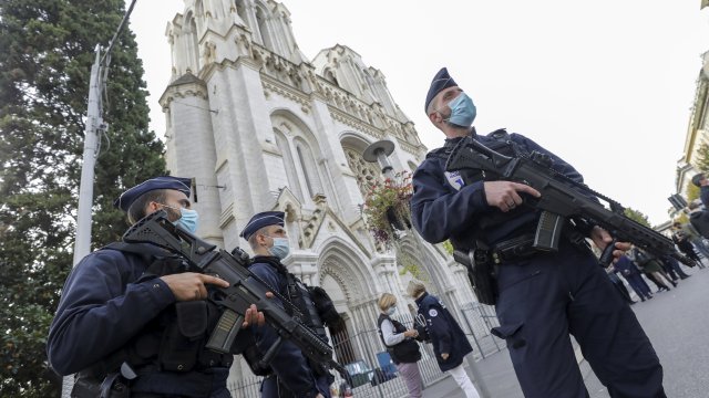 French police officers stand near Notre Dame church in Nice, southern France, Thursday, Oct. 29, 2020.