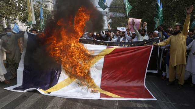 Religious group burns French flag