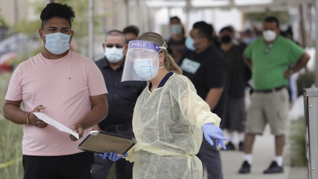 California health care worker directs people through a coronavirus testing site