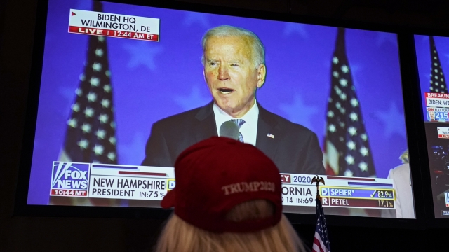Donald Trump supporter watches Democratic candidate Joe Biden speak on television.