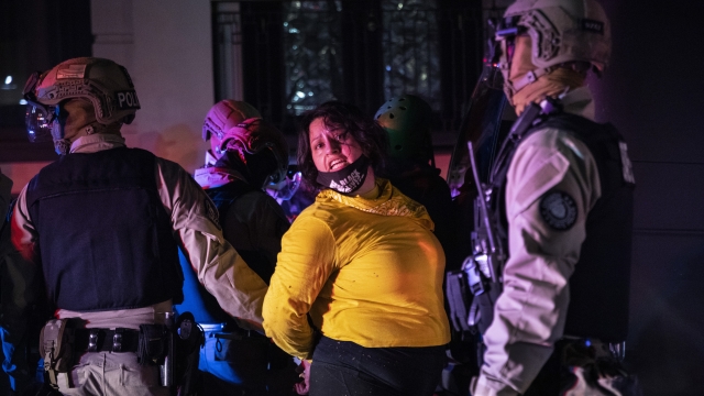 Police arrest a protester as clashes during a march following the presidential election Wednesday, Nov. 4, 2020, in Portland.