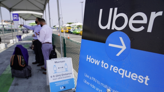 Travelers request an Uber ride at Los Angeles International Airport's LAX-it pick up terminal.