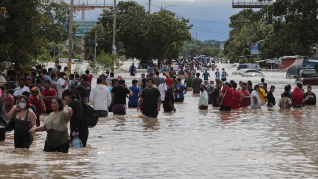 Residents in Honduras wade through flooding from Hurricane Eta