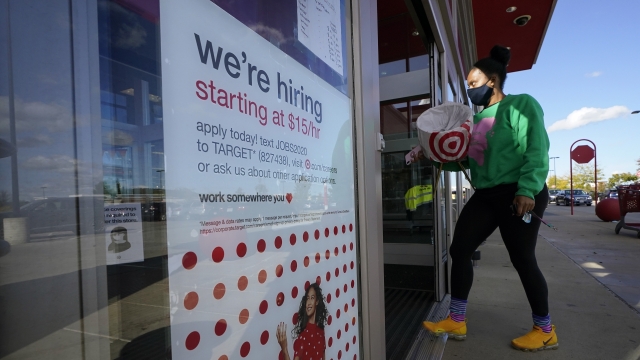 A passerby walks past a hiring sign while entering a Target store in Massachusetts