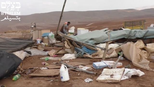 Palestinians in the West Bank demolished village of Khirbet Humsah search through rubble
