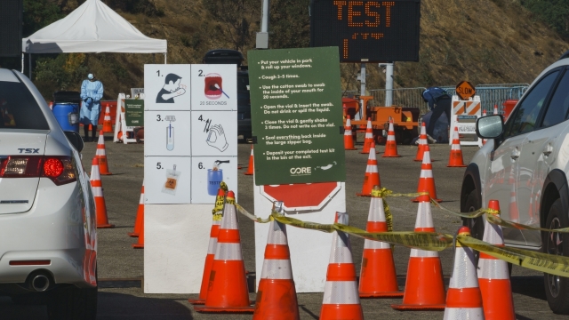 Instructions to perform a COVID-19 virus self-test are displayed for drivers at Dodger Stadium.