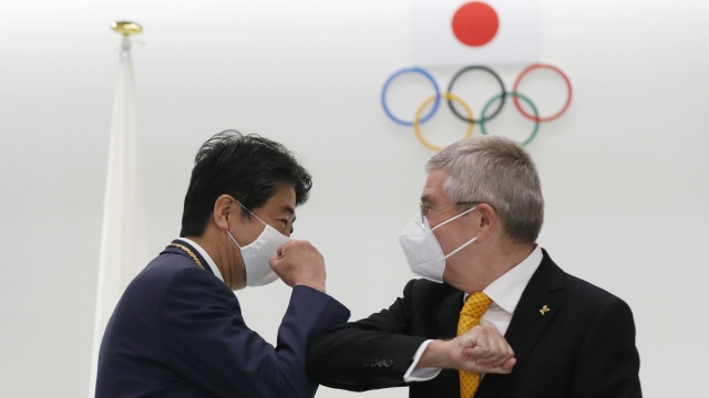 Former Japan's Prime Minister Shinzo Abe, left, and Thomas Bach, President of the International Olympic Committee.
