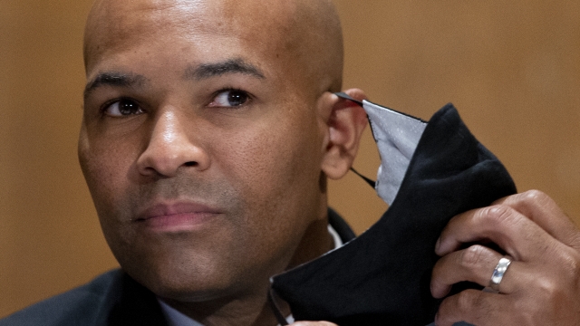 Surgeon General Jerome Adams takes off his face mask as he appears on Capitol Hill in Washington on Sept. 9, 2020.