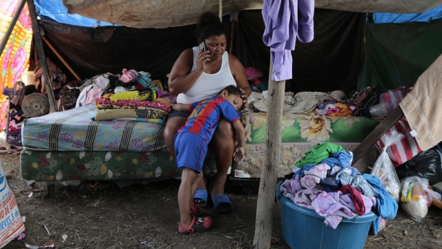 Wendy Guadalupe Contreras who was left homeless after the last storm hit the area, comforts her son in Honduras before Iota.
