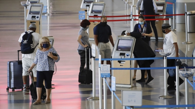 Travelers check in at the American Airlines terminal at the Los Angeles International Airport on May 28, 2020.