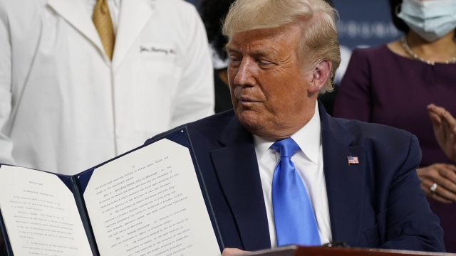 President Trump displays an executive order on health care signed in September.