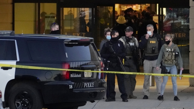 Police officers and FBI agents outside Mayfair Mall in Wauwatosa, Wisconsin, following Friday night shooting.