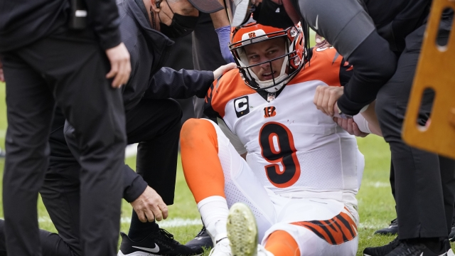 Cincinnati Bengals quarterback Joe Burrow (9) is helped getting off the field during the second half of an NFL football game