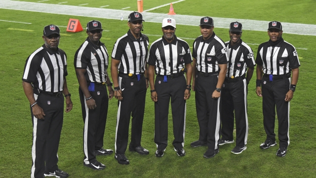 NFL's first all-black officiating crew poses for a photo prior to the game.