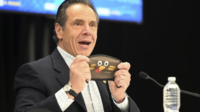 State of New York, New York Gov. Andrew Cuomo holds up a new Thanksgiving-themed face mask