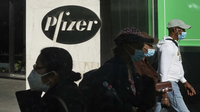 Pedestrians walk past Pfizer headquarters in New York