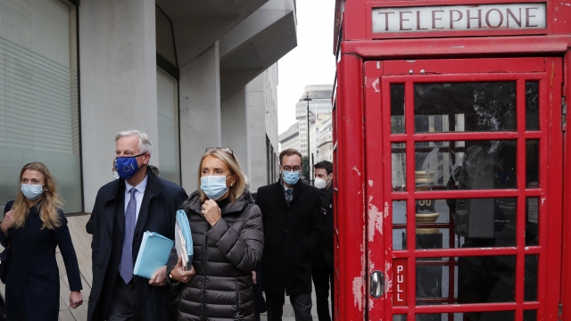 EU Negotiator Michel Barnier walks by an iconic UK phone booth
