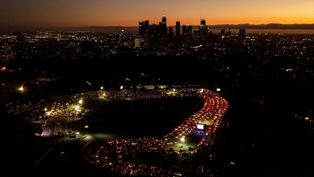 Motorists wait in long lines to take a coronavirus test in a parking lot at Dodger Stadium in Los Angeles, California