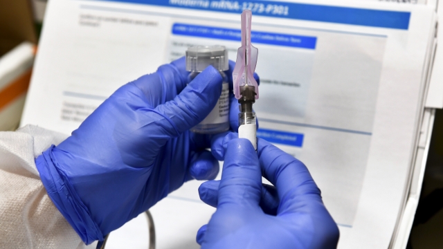 A shot is prepped that is part of a possible COVID-19 vaccine, developed by the National Institutes of Health and Moderna.