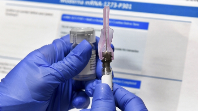 Nurse prepares syringe of vaccine