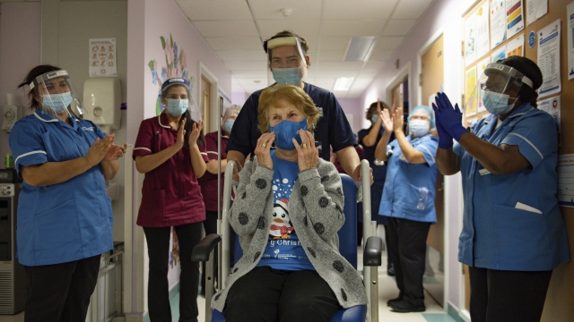 Margaret Keenan is applauded by hospital staff after becoming the first patient in the U.K. to receive a COVID-19 vaccine