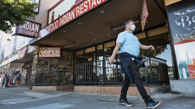 A man walks past an Indian restaurant in Los Angeles