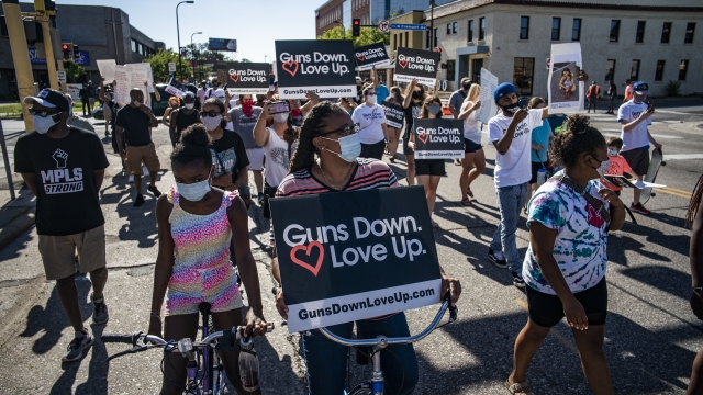 Demonstrators march in the street during an anti-violence rally in Minneapolis, Minnesota