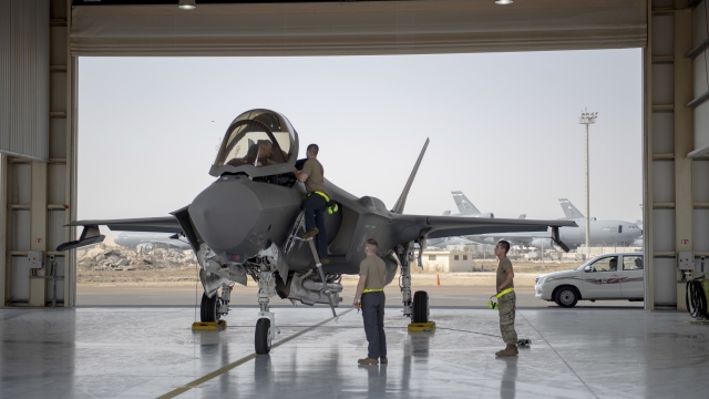 An F-35 fighter jet pilot and crew prepare for a mission at Al-Dhafra Air Base in the United Arab Emirates