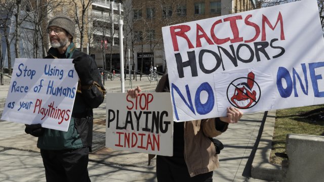 Protesters call for Cleveland's Major League Baseball team to drop the use of Indians from its team name