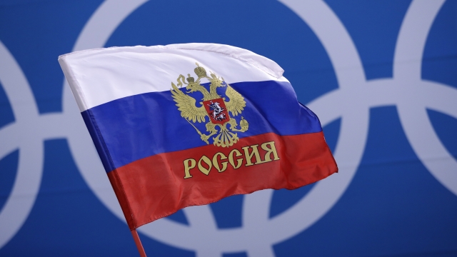 Russian flag in front of the Olympics logo.