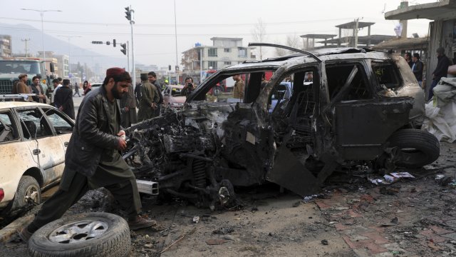 People gather near the site of a deadly bombing attack in Kabul, Afghanistan.