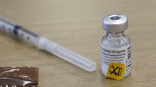 A syringe and vial of COVID-19 vaccine