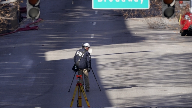 A member of the FBI surveys the street damage following a Christmas Day suicide bombing in Nashville, Tennessee
