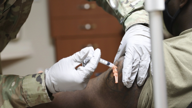 Sgt. Parmer Smith administers one of the first COVID-19 vaccines