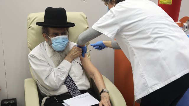 An ultra-Orthodox Jewish man receives a COVID-19 vaccine at a medical center in Jerusalem, Monday, Dec. 21, 2020