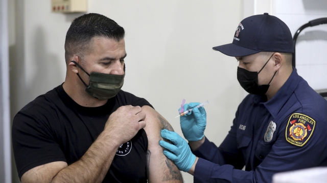 A Los Angeles firefighter receives a COVID-19 vaccine shot