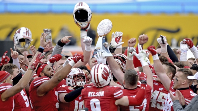 Wisconsin players with the Duke's Mayo Bowl trophy