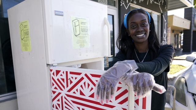 Sherina Jones poses with one of her community refrigerators