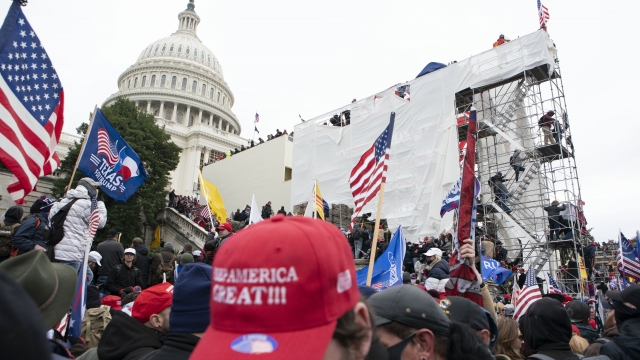 Pro-Trump rioters climb scaffolding