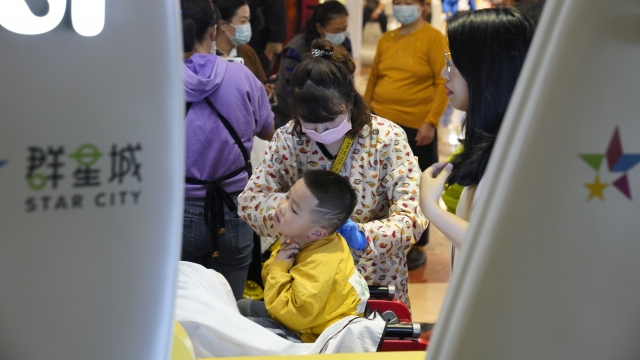 A child gets a hair cut at a barber at a mall in Wuhan in central China's Hubei province