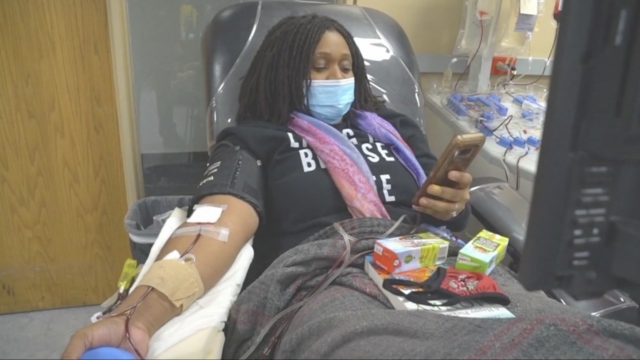 Woman donates blood.