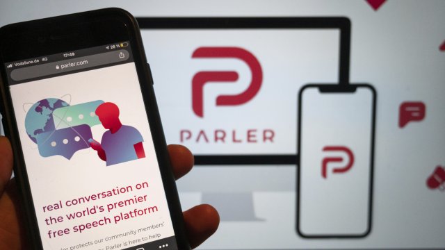 The Parler app is displayed on a phone