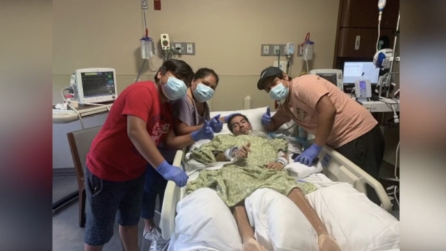 Family poses with their hospitalized father.