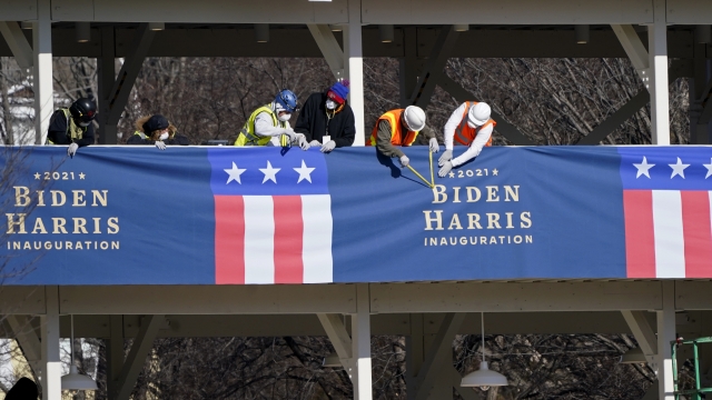 Workers put up bunting on a press riser ahead of Inauguration Day