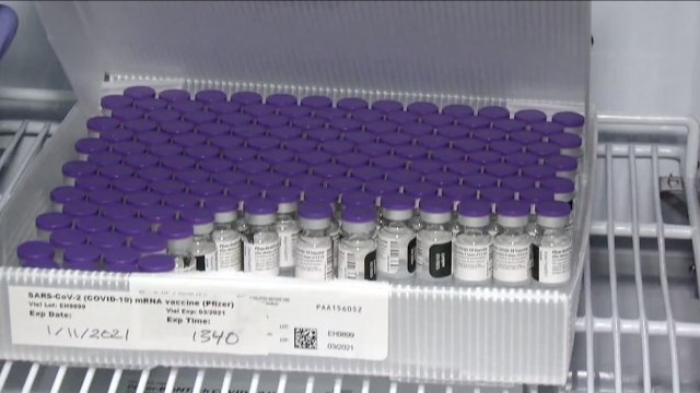 Vaccine vials sit in a box.