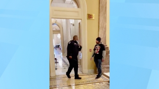 Capitol Police Officer Eugene Goodman calls for backup as an angry mob approaches him inside the U.S. Capitol
