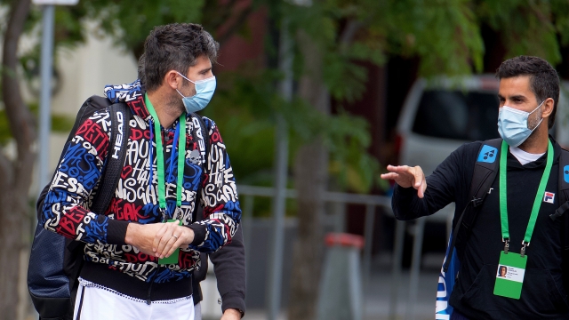 Italian tennis player Simone Bolelli, left, and Argentina's Maximo Gonzalez are escorted to their training session